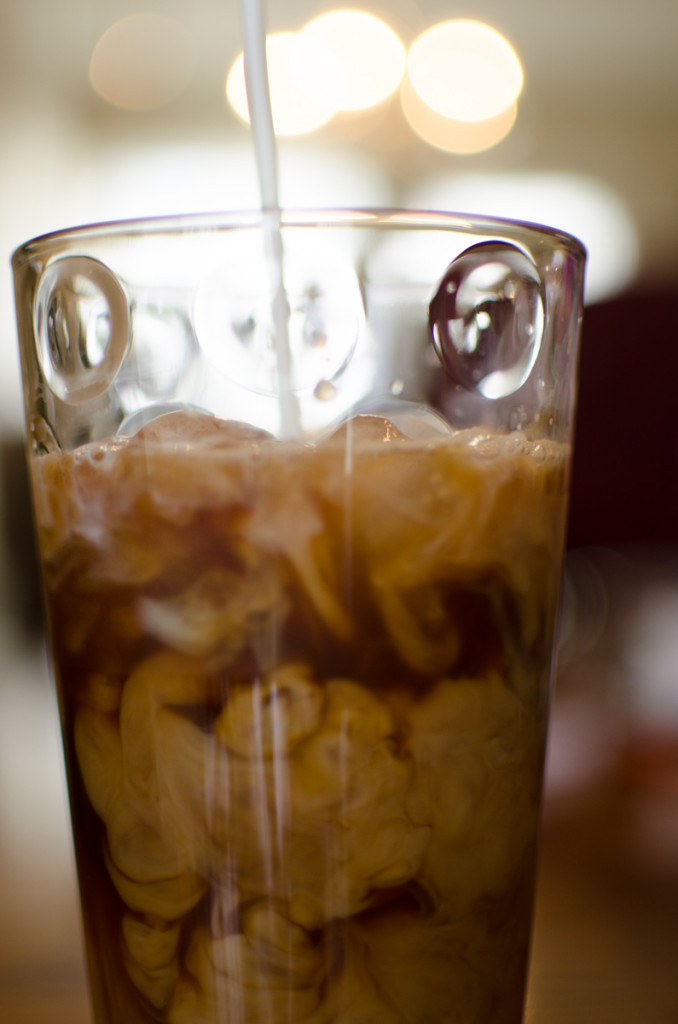 Pouring milk into ice coffee